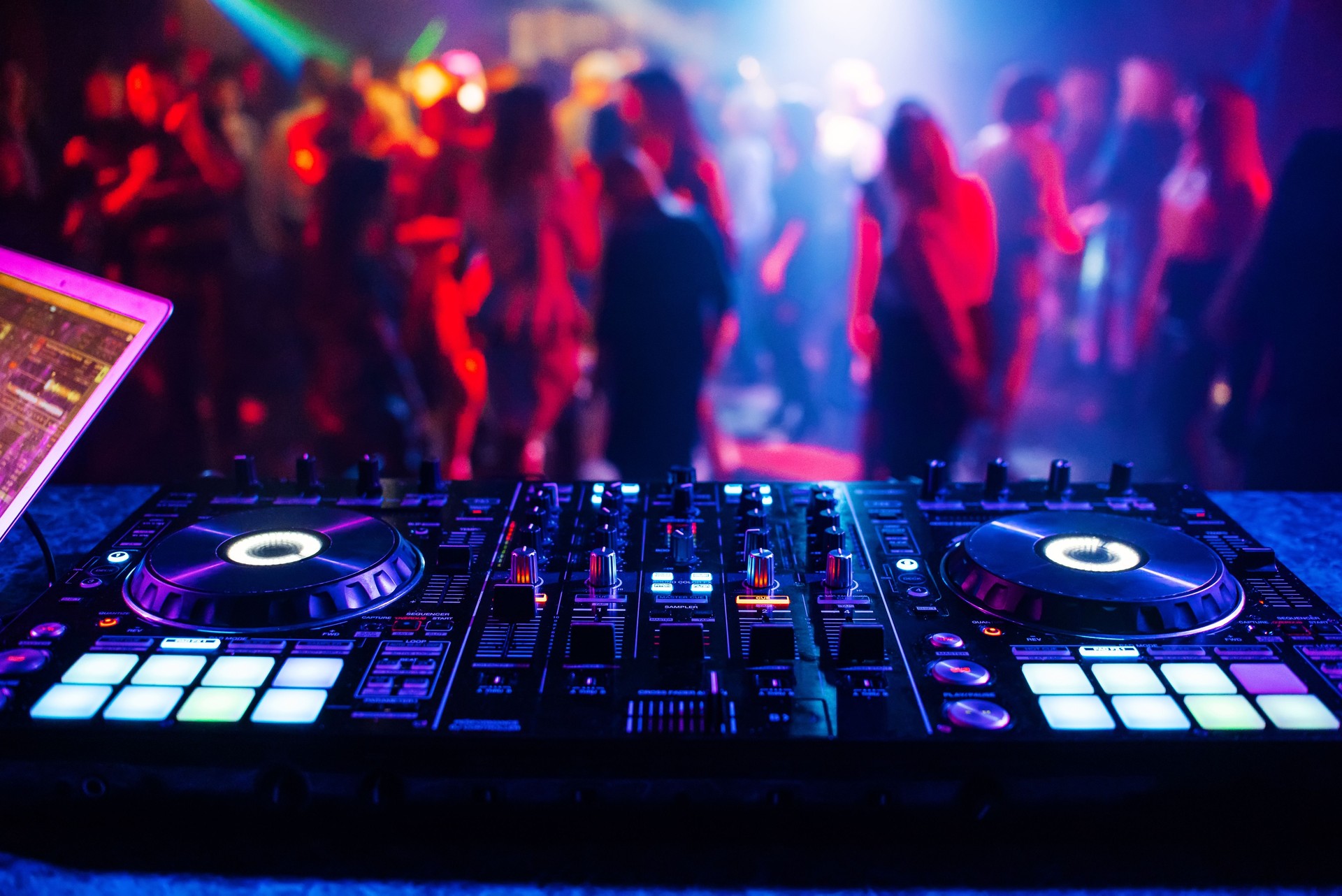 music controller DJ mixer in a nightclub at a party